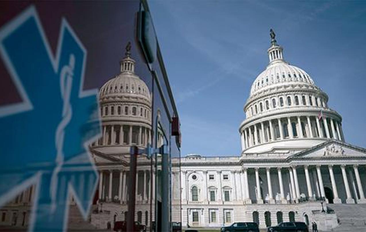 An image of the Capitol building is reflected in the surface of an ambulance. 