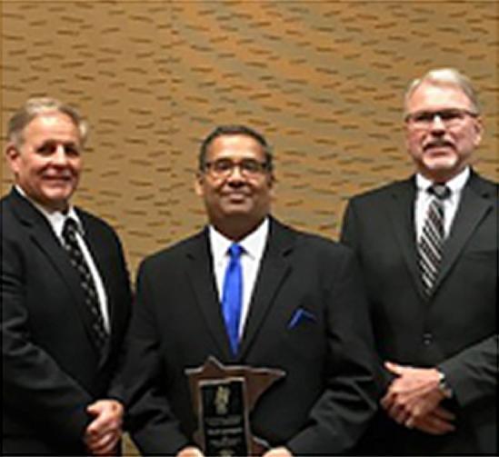 Deputy Commissioner of Corrections Ron Solheid, Mitch Gundgovi and Commissioner of Corrections Tom Roy